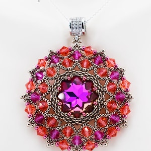 May include: A handcrafted pendant necklace featuring a large, faceted purple gemstone at the center, surrounded by a beaded design in shades of peach, pink, and dark pewter. The pendant hangs from a delicate silver chain.
