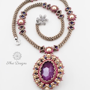 May include: A beaded necklace with a large purple gemstone pendant. The necklace is made with small gold, pink, and blue beads. The pendant is surrounded by a beaded frame with gold, pink, and blue beads. The necklace is called "Sandra Necklace (c) 2025 Orchid/dark Pewter".