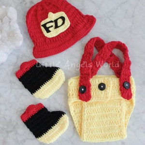 May include: A crocheted firefighter costume for a baby, featuring a red hat with a yellow "FD" patch, yellow dungarees with red straps, and black and yellow booties.