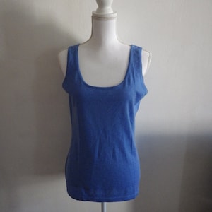 May include: A blue sleeveless tank top on a white mannequin.