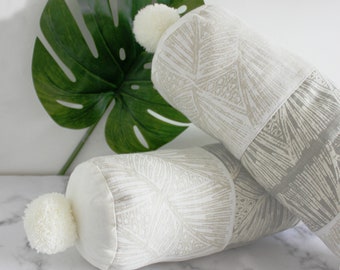 Set of two cylinder shaped moroccan inspired pillow cases with pompoms