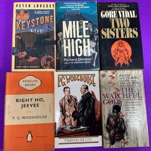 May include: A collection of six vintage paperback books arranged in two rows. Titles include Keystone by Peter Lovesey, Mile High by Richard Condon, Two Sisters by Gore Vidal, Right Ho, Jeeves by P.G. Wodehouse, Psmith in the City, and The Watchful Gods.