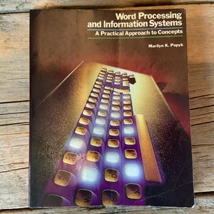 May include: A book titled "Word Processing and Information Systems: A Practical Approach to Concepts" by Marilyn K. Popyk. The cover features a close-up of a computer keyboard with glowing keys.