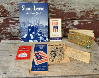 May include: A collection of vintage pamphlets and booklets, including "Shore Leave in New York", "Guide", "A Guide to U.S. Army Insignia and Decorations", "Members Armed Forces", "Straight Talk About the 6th War Loan", "Army Song Book", and "Boat Mail and Station".