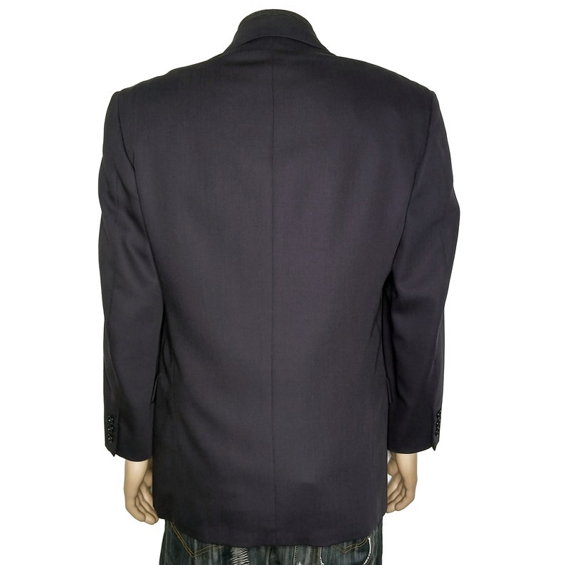 May include: A dark blue blazer with a single-breasted closure and long sleeves.
