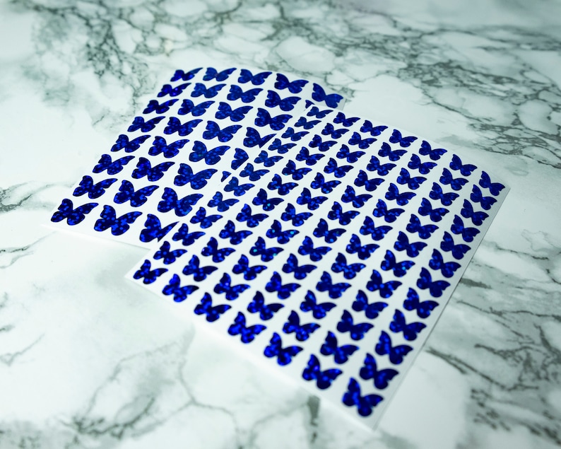 May include: Sheets of white paper with blue glitter butterfly stickers.