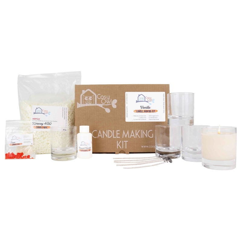 May include: A candle making kit with a brown box, white wax flakes, glass jars, wicks, and a bottle of vanilla fragrance oil. The box has the text "Cosy Owl" and "Vanilla Candle Making Kit".