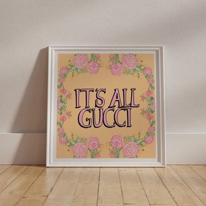 "It's All Gucci" mantra, a positive floral & typography wall art. 
Vibrant yellow contrasting against pink lettering, with pink and green floral details around the border, creating a bold and colourful feel-good poster.