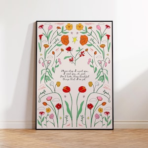 May include: A framed vertical poster featuring a light pink background with a symmetrical arrangement of colorful line-art flowers in red, orange, yellow, and pink. The center text reads: Please stay I want you. I need you, oh, god. Don't take, these beautiful things that I've got.