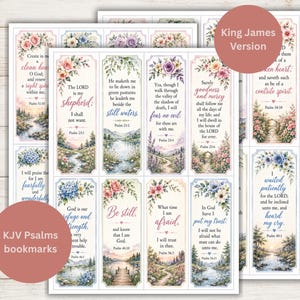 May include: A collection of rectangular paper bookmarks featuring floral illustrations and printed Bible verses from the King James Version. Each bookmark displays landscape scenes, including rivers, forests, and paths, paired with elegant typography.