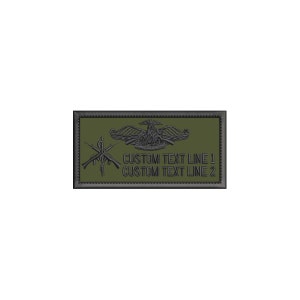 May include: A rectangular olive green embroidered patch with a black border. It features a black winged emblem, a caduceus symbol with crossed rifles, and two lines of text that read CUSTOM TEXT LINE 1 and CUSTOM TEXT LINE 2 in black stitching.