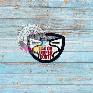 May include: A black and white embroidered patch with a diaper shape and the text "Dad on Diaper Dooty" in red.
