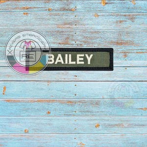 May include: A green and black name tag with the name "BAILEY" printed in white letters.