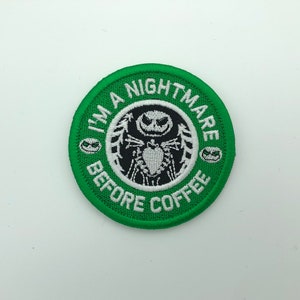 May include: Green embroidered patch with a white circle and the text "I'm a Nightmare Before Coffee" in white. The circle features a black and white illustration of Jack Skellington from the movie "The Nightmare Before Christmas".