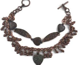 Copper charm bracelet with hearts and textured links and copper beads