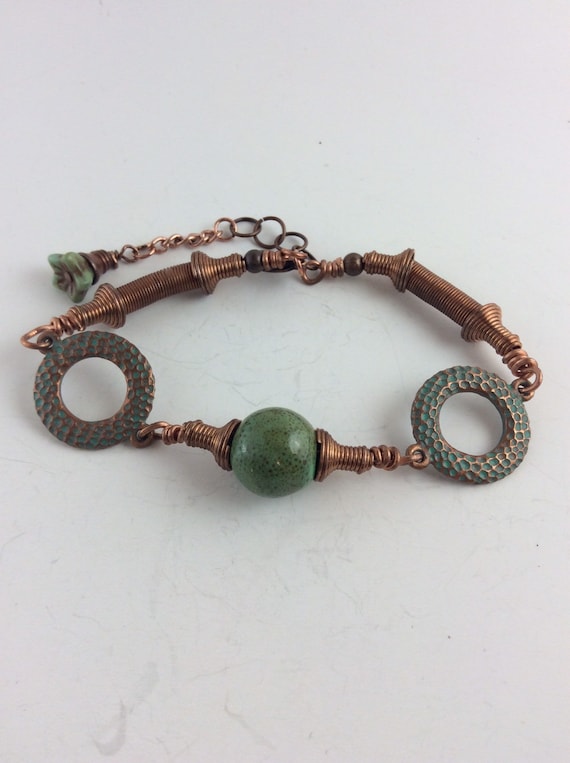 Copper coil and oxidized copper discs with copper speckled green beads bracelet