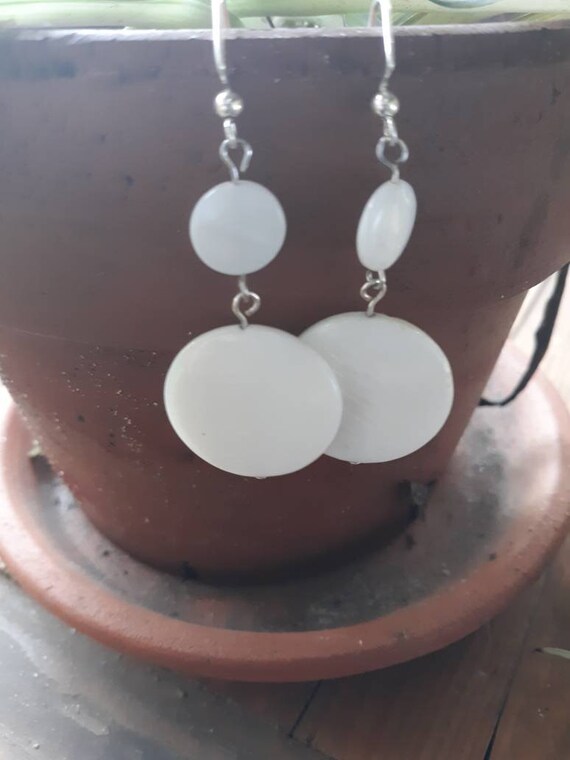 White pressed glass earrings with silver tone metal
