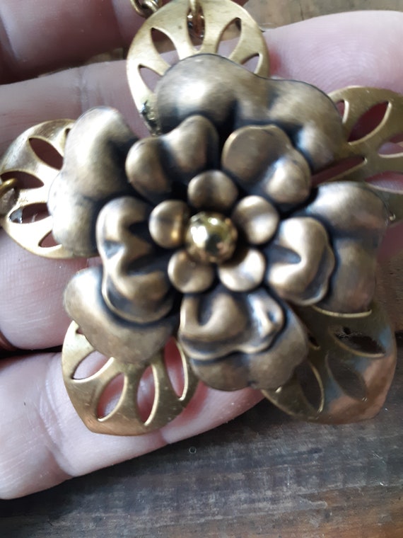 Assemblage necklace with brass flowers, handmade brass chain and hand worked heart clasp