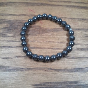 May include: A black hematite beaded bracelet with a silver clasp.
