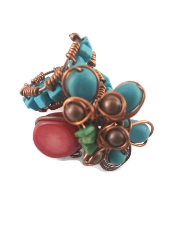 Large adjustable multi stone statement ring with turquoise color and red stones.