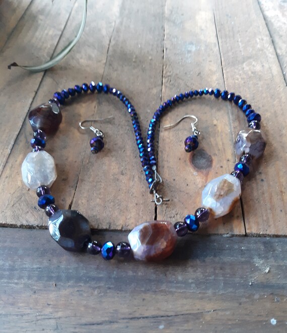 Necklace and earring set has purple and lilac glass beads with a silver tone toggle closure,  silver color ear wires