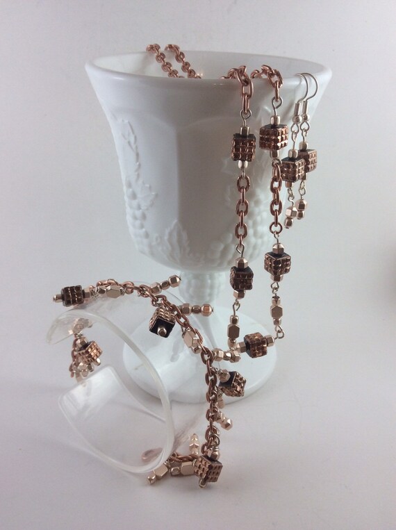 Rose gold 3 piece jewelry set with soft rose colored beads and cubes and rose gold plated chain, necklace, bracelet and earrings