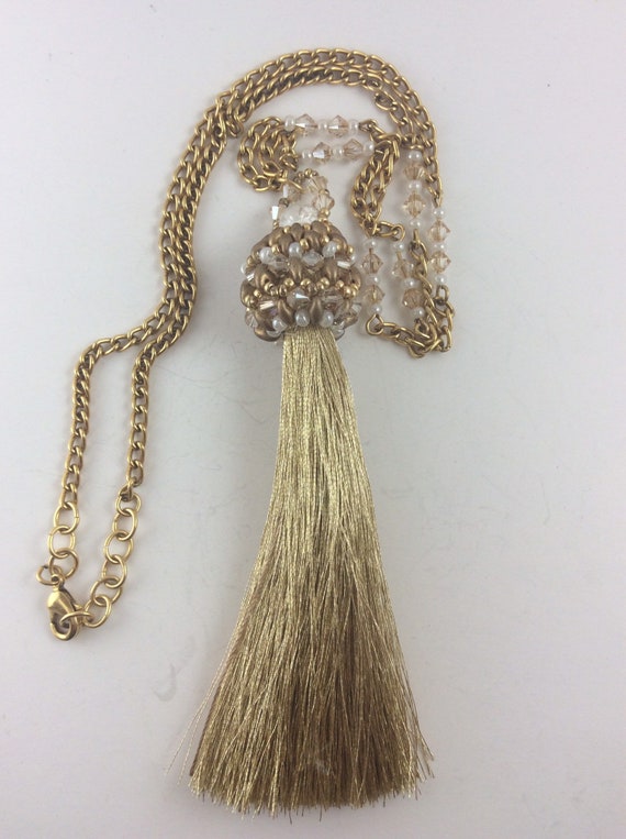 Golden tassel fringe statement necklace with hand beaded accents in gold and white