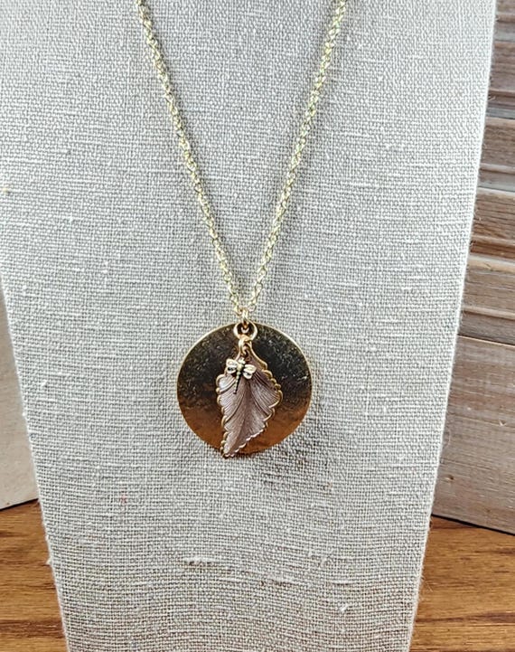 Pendant necklace with gold color chain, upcycled brass disc, leaf charm and dragonfly charm