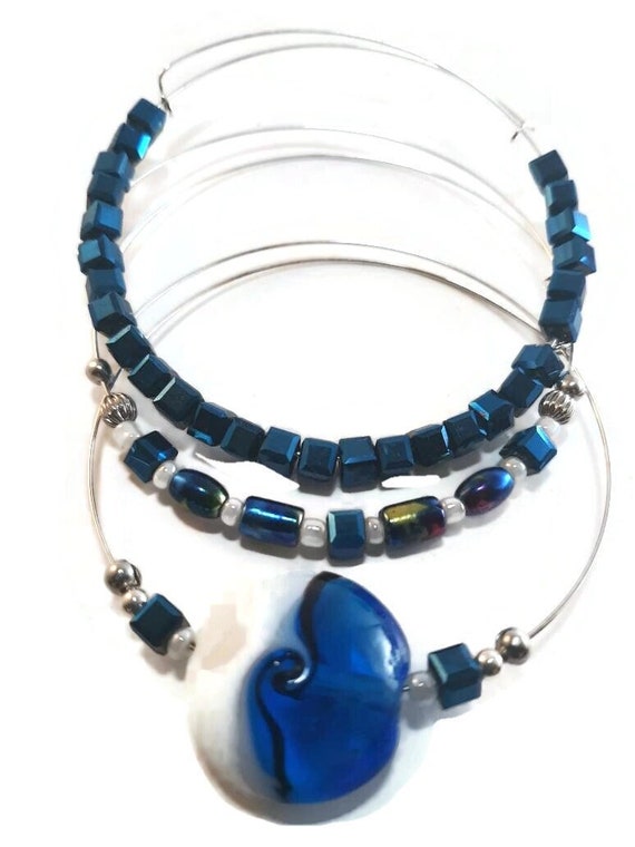Expandable silver and blue bangle bracelets, shimmering blue glass beads, lamp work focal