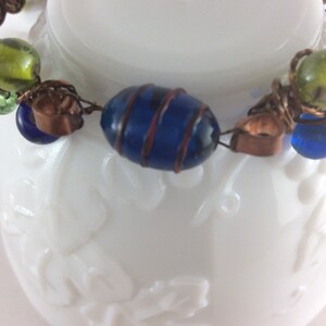 Copper bangle with blue and green lamp work beads