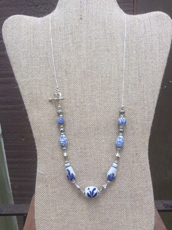 Blue and white ceramic bead necklace set with silver heartclosure