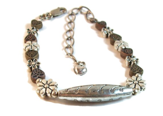 Southwestern style  bracelet in various metals, flower and heart shaped beads