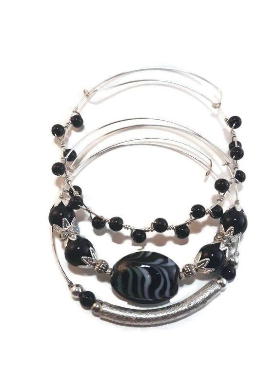 Expandable stacking bangles in silver with lamp work glass focal and round black beads, sterling silver wire