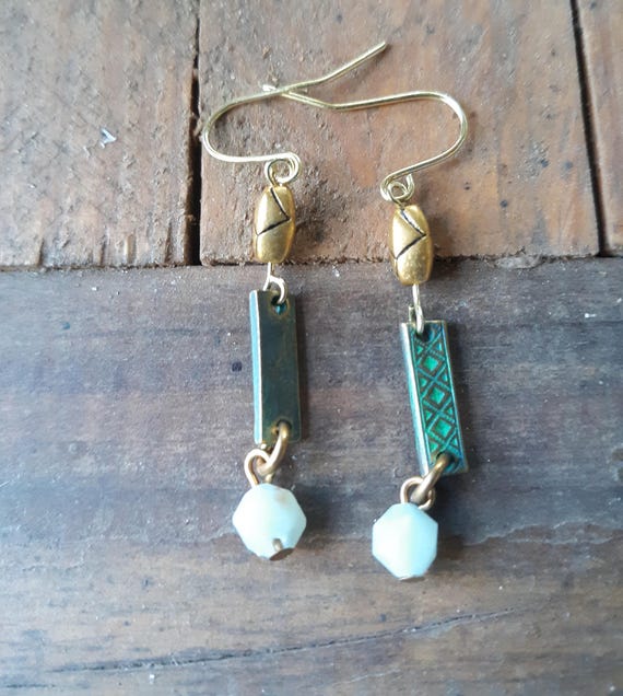 Green dangle earrings with gold color ear wires and gold color beads and a small light green glass bead