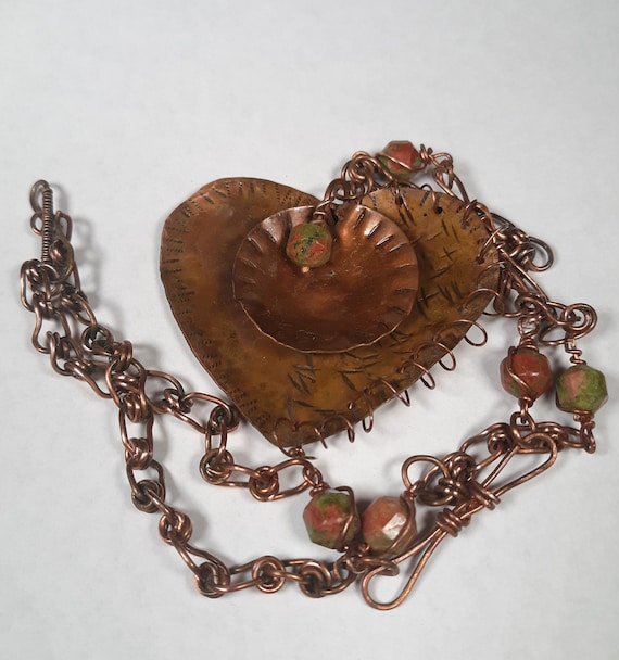 Copper necklace with Unakite lantern beads in swirled copper, green and black with a heart pendant, a textured disc, handmade chain