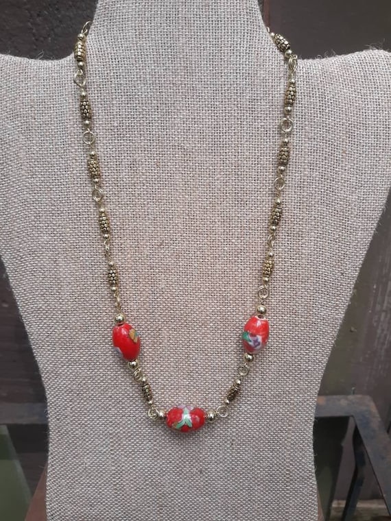 Necklace with red porcelain beads, gold tone bead, gold tone hook and eye closure