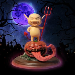 May include: A small, yellow, devil-like figurine with a red trident and a tail, standing on top of a large, orange, pumpkin-shaped object with a wide, open mouth and a long, pink tongue.