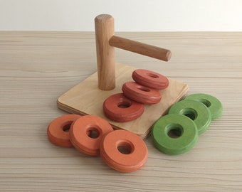 3 Coloured Discs On Horizontal Dowel.