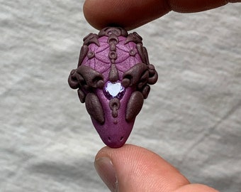 Handmade alien face polymer clay pendant with amethyst