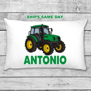 May include: A white pillow with a green tractor illustration and the name "ANTONIO" in green text.