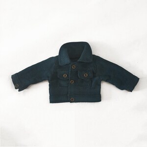May include: A dark green corduroy jacket with a button closure and two front pockets.