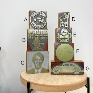 Vintage metal letterpress print type advertising on wooden blocks, various designs.