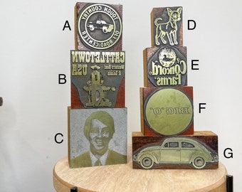 Vintage metal letterpress print type advertising on wooden blocks, various designs.