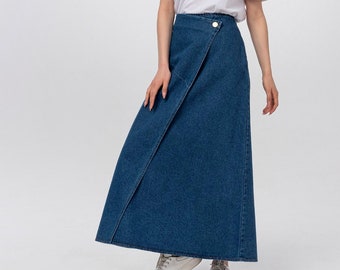 May include: A woman wearing a white t-shirt and a blue denim wrap skirt. She is wearing white trainers.