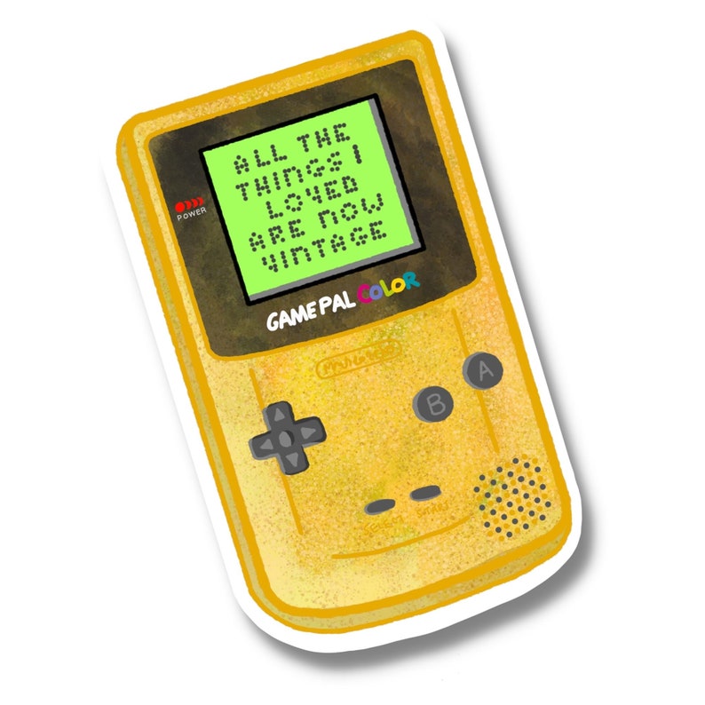 May include: A yellow Game Boy Color handheld video game console with a green screen displaying the text "ALL THE THINGS I LOVED ARE NOW VINTAGE".