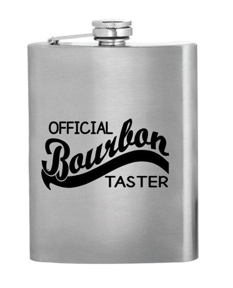 May include: A silver flask with the text "OFFICIAL Bourbon TASTER" printed on it.