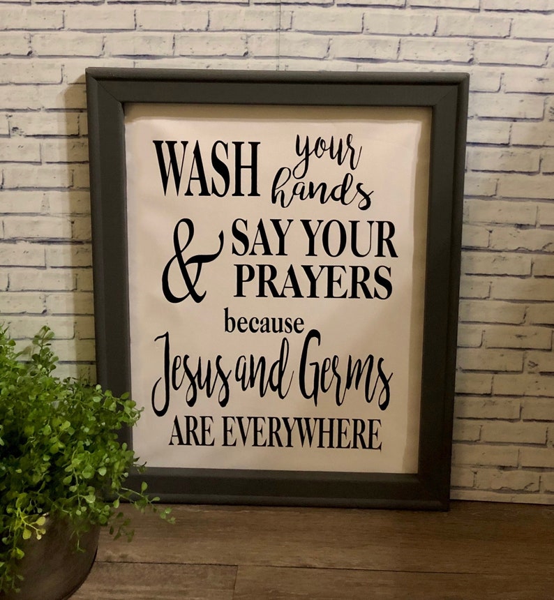 May include: A framed sign with a white background and black text that reads "Wash your hands & say your prayers because Jesus and germs are everywhere".