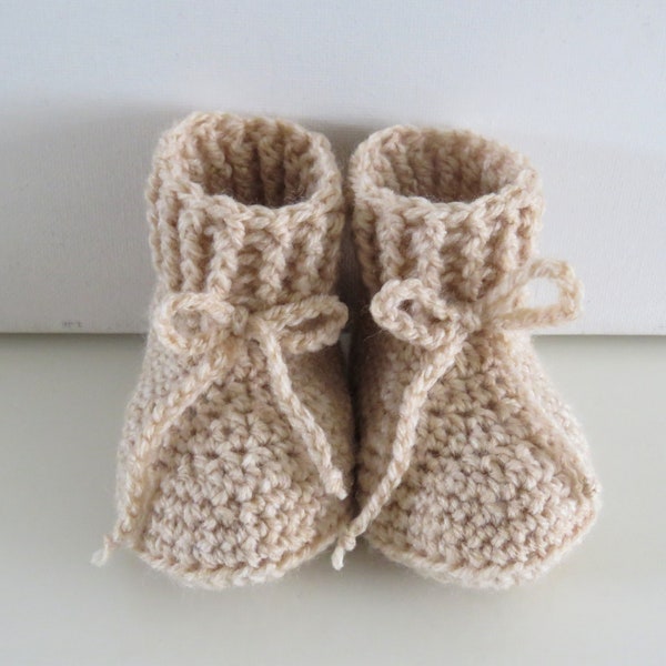 beige crocheted baby shoes