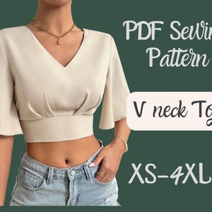 May include: A PDF sewing pattern for a V-neck top. The pattern includes sizes XS-4XL. The image shows a model wearing a beige crop top with short sleeves.