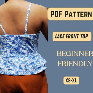 May include: PDF pattern for a lace front top. The pattern is beginner friendly and includes sizes XS-XL. The image shows a woman wearing a blue and white floral top with a ruffled bottom.